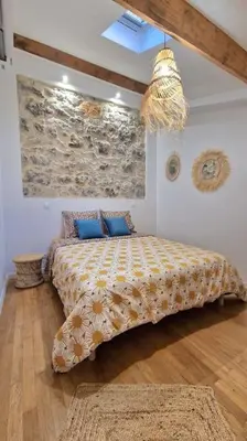 a bedroom with a large bed with blue pillows at T3 duplex cosy & calme au port - Tram in Nice