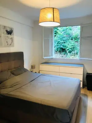 a bedroom with a large bed and a window at Bel appartement - 50m2 à 7 minutes du centre au calme in Nice