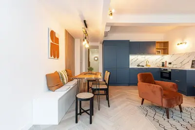 a kitchen and a living room with a table and chairs at Ultra Central 2 Bdr AC & Parking in Nice