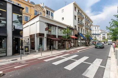 a city street with buildings and a car on the road at Ultra Central 2 Bdr AC & Parking in Nice