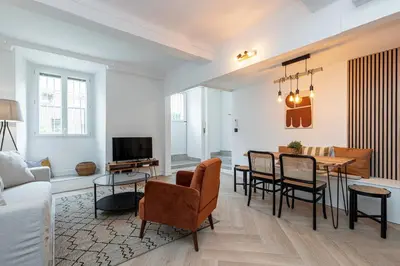 a living room with a couch and a table at Ultra Central 2 Bdr AC & Parking in Nice
