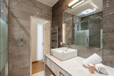 a bathroom with a sink and a mirror at Confort Downtown 2 Bdr in Nice
