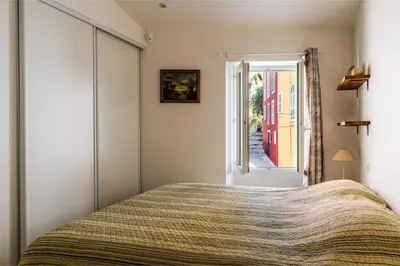 a bedroom with a bed and a window at Cocon dans la vieille ville in Villefranche-sur-Mer