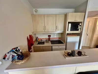 a kitchen with white cabinets and a counter top at Appartement Nice aéroport seafront with pool in Cros-de-Cagnes