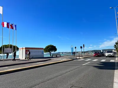 an empty street with cars parked on the side of a road at Appartement Nice aéroport seafront with pool in Cros-de-Cagnes