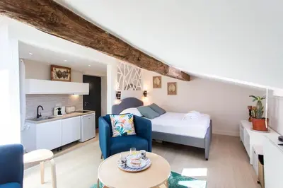 a living room with a bedroom and a bed and a table at #49 Perfect location Saleya old town 2mins to Sea AC in Nice