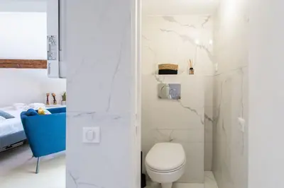 a bathroom with a white toilet in a room at #49 Perfect location Saleya old town 2mins to Sea AC in Nice