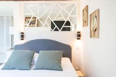 a bedroom with a bed with a blue headboard at #49 Perfect location Saleya old town 2mins to Sea AC in Nice
