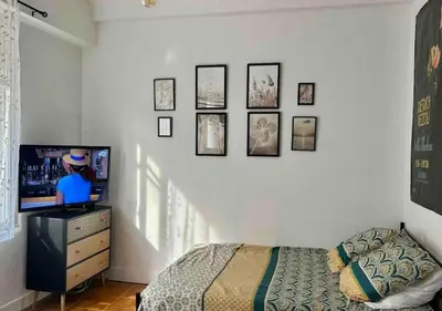 a bedroom with a bed and a flat screen tv at Studio calme Nice hyper centre in Nice