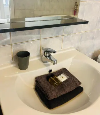 a bathroom sink with a soap dispenser on it at Studio calme Nice hyper centre in Nice