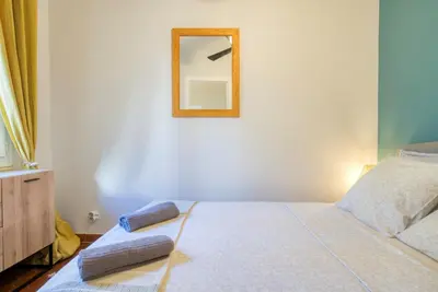 a dresser with a window and a yellow curtain at Cosy, modern, fully equipped, air conditioning, Nice historical, old town, 1minute walk from beach - 