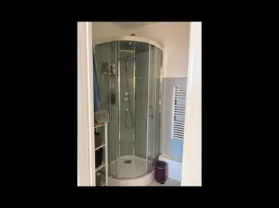 a bathroom with a shower with a glass enclosure at Vue mer, 2 pièces lumineux in Nice