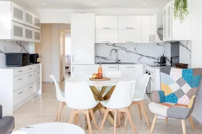 a kitchen with a table and chairs in a kitchen at L28 Suite Californie 1min walk sea 3BDR/ AC & balcony in Nice