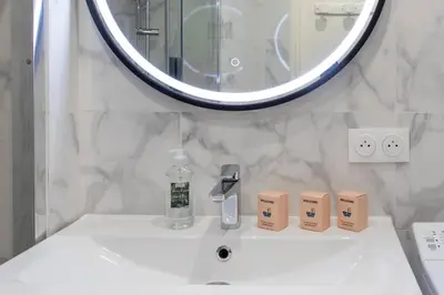 a bathroom with a mirror and a white sink at L28 Suite Californie 1min walk sea 3BDR/ AC & balcony in Nice