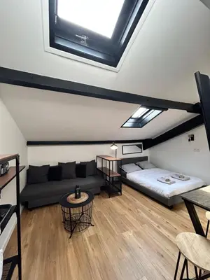 a living room with a bed and a couch at Studio HYPER CENTRE in Nice