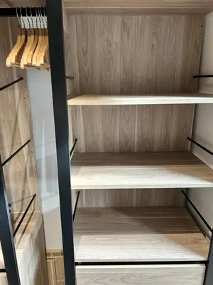 a walk in closet with wooden shelves at Studio HYPER CENTRE in Nice