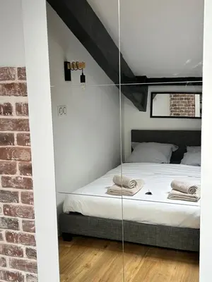 a bed in a room with a glass wall at Studio HYPER CENTRE in Nice