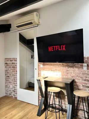 a meeting room with a netflix sign on a brick wall at Studio HYPER CENTRE in Nice