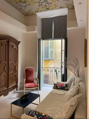 a living room with a bed and a chair at Luxury apartment In the heart of old town Nice. in Nice