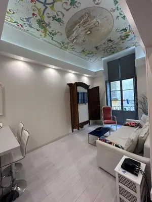 a living room with a ceiling with a painting on it at Luxury apartment In the heart of old town Nice. in Nice
