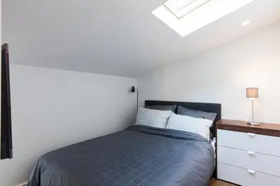 a bedroom with a bed and a skylight at Duplex Nice Avenue Jean-Médecin in Nice
