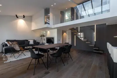 a dining room and living room with a table and chairs at Duplex Nice Avenue Jean-Médecin in Nice