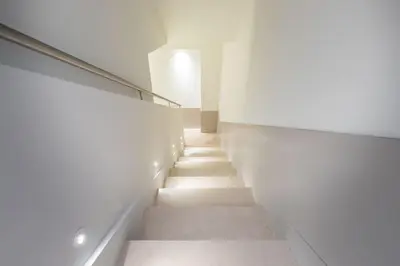 a staircase in a building with white walls and white floors at Duplex Nice Avenue Jean-Médecin in Nice
