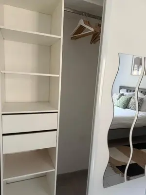 a bedroom with a closet with a bed in it at Bas de Villa à 15 min de Nice avec piscine in Carros