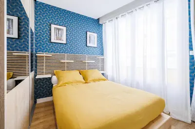 a bedroom with a large yellow bed in a room at Nice Renting - OFFENBACH - Luxury Apartment Fully Equipped Center in Nice