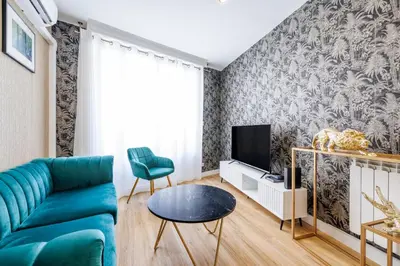 a living room with a blue couch and a tv at Nice Renting - OFFENBACH - Luxury Apartment Fully Equipped Center in Nice