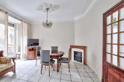 a dining room with a table and chairs at Nidusudest - Spacieux appartement in Nice
