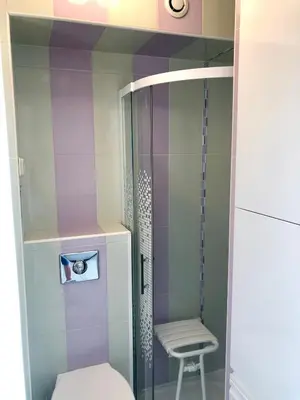 a small bathroom with a toilet and a chair at Studios Nice Gambetta in Nice