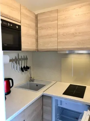 a kitchen with a sink and wooden cabinets at Studios Nice Gambetta in Nice
