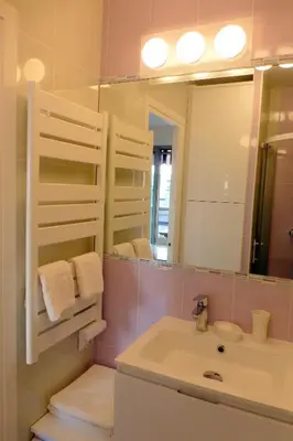 a bathroom with a sink and a mirror at Studios Nice Gambetta in Nice