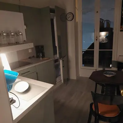 a kitchen with a counter and a table and a window at MAO in Nice