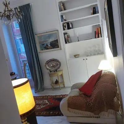 a living room with a couch and a lamp at MAO in Nice