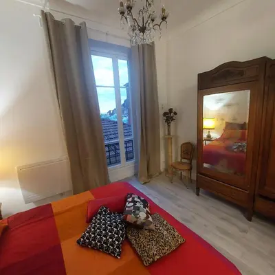 a bedroom with a bed and a large window at MAO in Nice