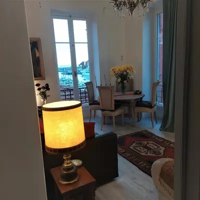 a living room with a table and a lamp at MAO in Nice