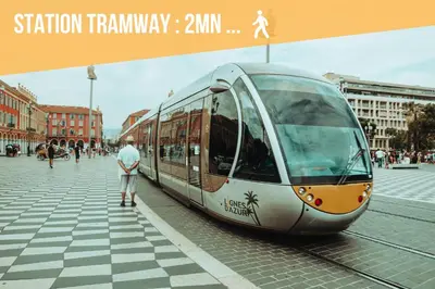 a man is standing next to a train at Studio cozy et moderne dans résidence à Nice in Nice