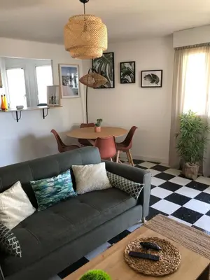 a living room with a couch and a table at Beautiful flat with balcony and sea view in Saint-Laurent-du-Var