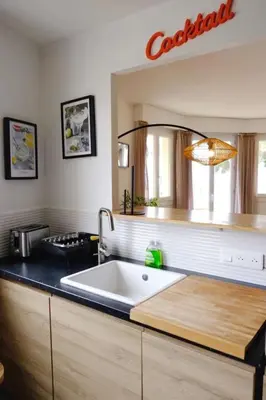 a kitchen with a large white sink in a kitchen at Beautiful flat with balcony and sea view in Saint-Laurent-du-Var