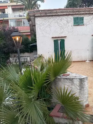 a house with a street light and some plants at Studio de 14m2 dans une maison in Cagnes-sur-Mer