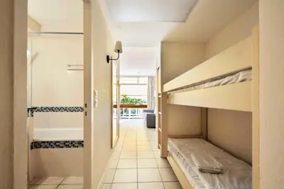 a hallway with two bunk beds in a room at Résidence Héliotel Marine - maeva Home - Studio 4 personnes - Confort MAE-5084 in Cros-de-Cagnes
