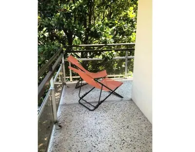 a red chair sitting on a balcony at Résidence Héliotel Marine - maeva Home - Studio 4 personnes - Confort MAE-5084 in Cros-de-Cagnes