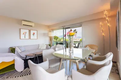 a living room with a table and chairs at BELLES TERRES AP4378 By Riviera Holiday Homes in Nice