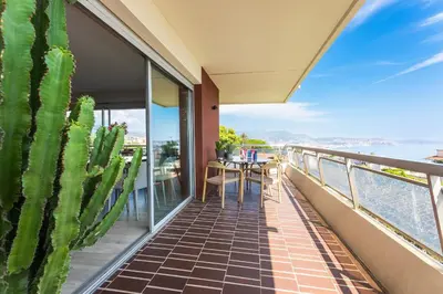 a balcony with a table and a cactus at BELLES TERRES AP4378 By Riviera Holiday Homes in Nice