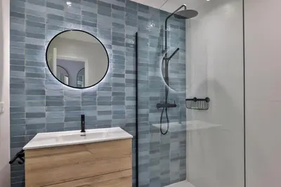 a bathroom with a mirror and a sink and a shower at Incroyable vue mer, 2 pièces refait à neuf avec piscine sur le toit/ WIFI/AC in Nice
