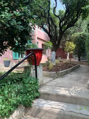 a red trash can sitting on the side of a sidewalk at Douceur d'Azur in Nice