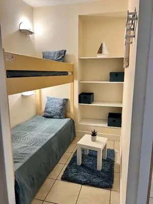 a small room with a bunk bed and a table at Nice Seaside Pool and Tennis in Nice