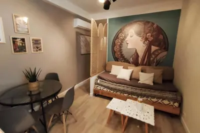 a room with a bed with a large painting on the wall at «l’Orient Express» joli 2 pièces fonctionnel in Nice